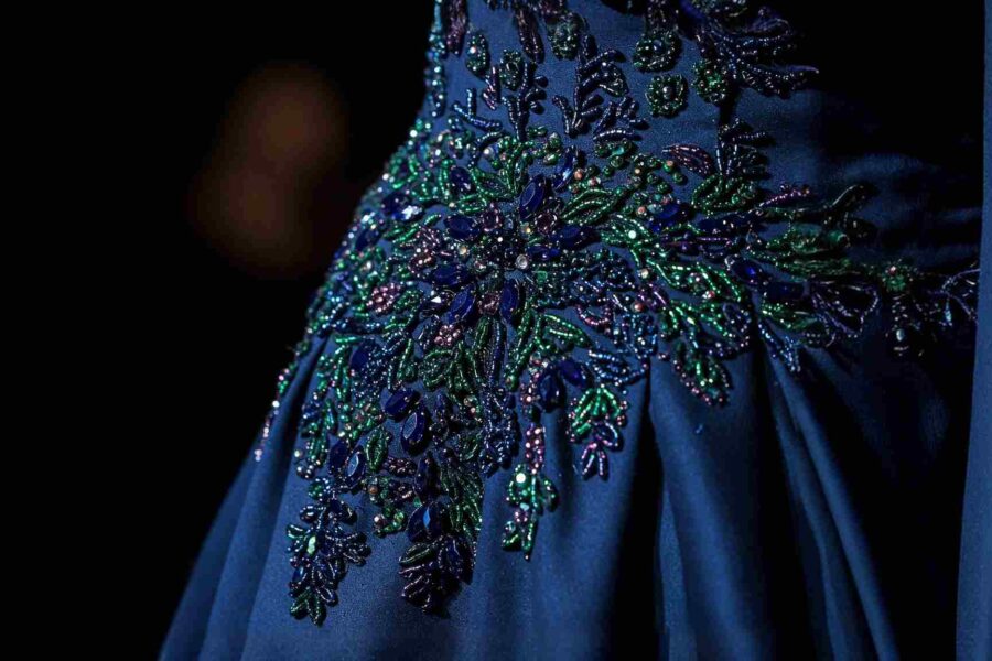 Hand beading techniques on luxury dress fabric
